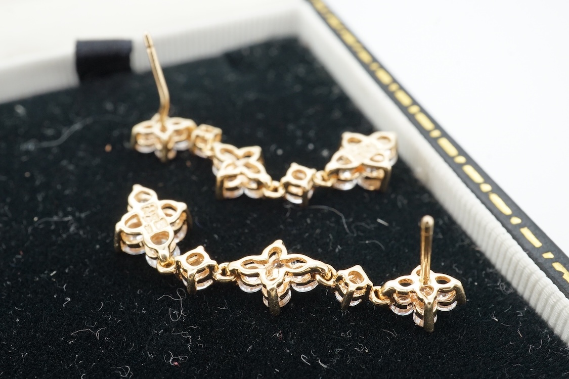 A modern yellow metal (stamped 585) and cubic zirconia set line bracelet, 18cm and a pair of similar drop earrings, together with a similar 9k and cubic zirconia set cluster ring, size N.